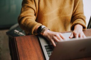 Woman using a laptop to write an eCommerce description