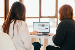 Two women working on a photography infographic